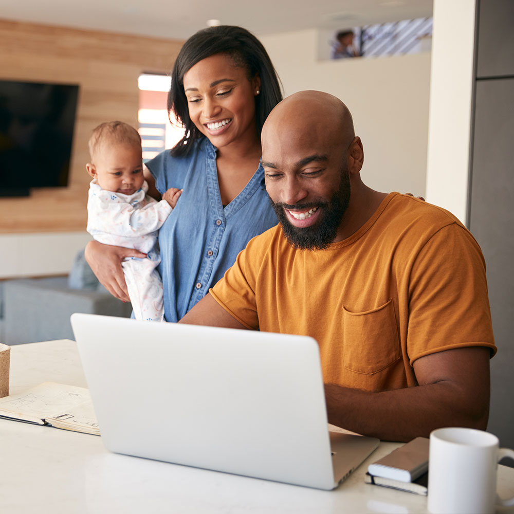 image of family using laptop